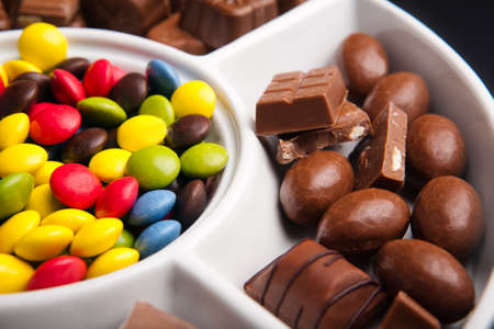 Colorful chocolate sweets with random pieces of chocolateの写真素材