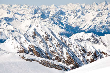 Winter landscape with lopes on a skiing resort in the Alps with mountains background