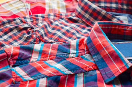 Close up of three red, colorful shirts の写真素材