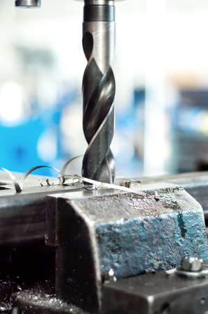 Mechanic drill making a hole in a metallic assembly