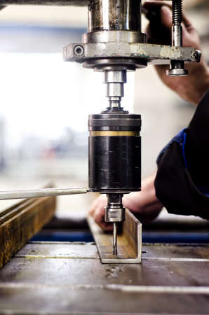 industrial engineer using a mechanical drill machine in a factoryの写真素材