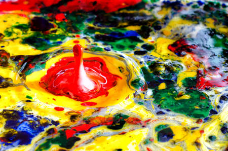 Colorful paint drops splashing in abstract paintの写真素材