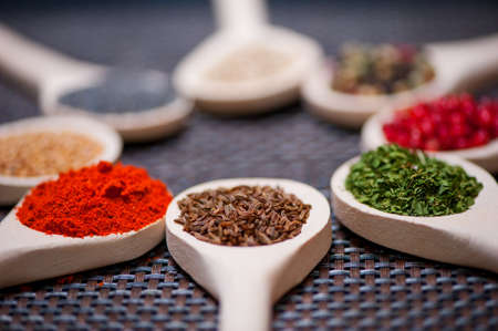 Various kind of spices on wooden spoon -  detail of carum carvi or caraway seedsの写真素材