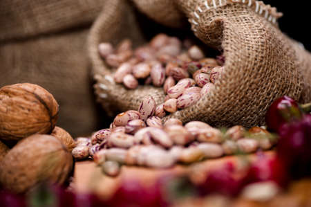 Fresh bean seeds with dried pepper and nuts in vintage packagingの写真素材