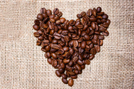 Bio fresh roasted coffee beans isolated on vintage clothの写真素材