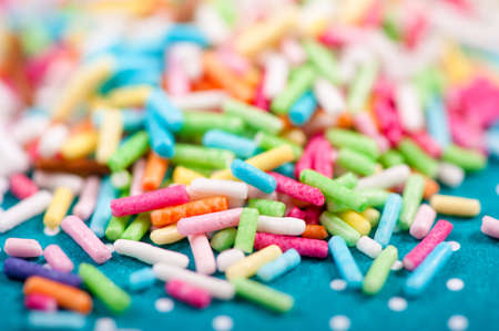 background of colorful sprinkles, jimmies for cake decoration or ice cream topping creams