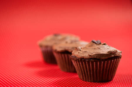 Close-up of colorful red muffins with dark chocolate topping and ice creamの写真素材