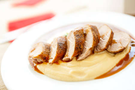 Close-up of grilled pork with mashed potatoes as main course at local restaurantの写真素材