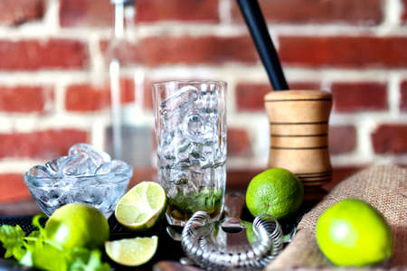 cocktail at bar, fresh alcoholic drink with limes and ice