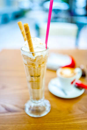Iced coffee, frappe, with whipped cream, almonds cream and cookieの写真素材
