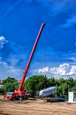mobile industrial crane installing a concrete and cement production plantの写真素材