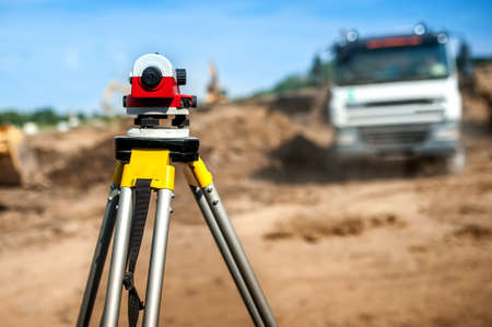surveyor engineering equipment with theodolite at highway infrastructure construction site