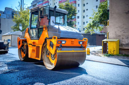 Heavy tandem Vibratory roller compactor working on asphalt pavement at road repairingの写真素材
