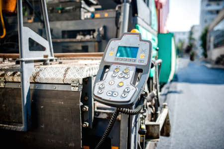 detail of operating and comand center on industrial asphalting paverの写真素材