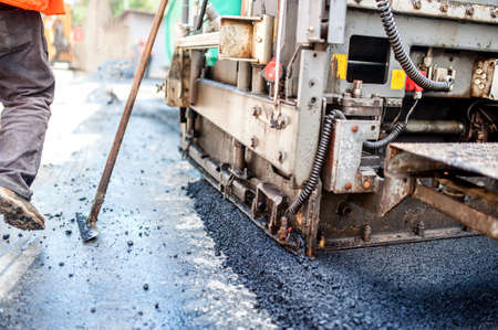 road construction with tools, workers and industrial machineryの写真素材