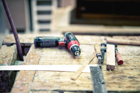 Cordless screwdriver and carpenter tools in wood industrial factoryの写真素材