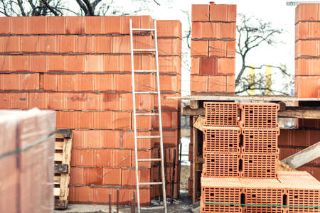 Wall building with professional bricks, construction site of new houseの写真素材