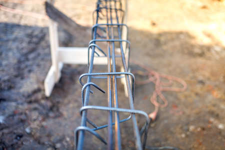 Reinforced heavy duty steel bars on new construction foundation site, infrastructure details and toolsの写真素材