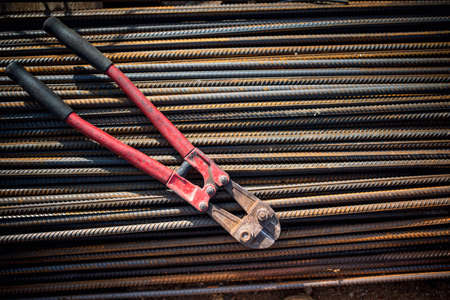 Reinforced steel bars and bolt cutter on building construction siteの写真素材