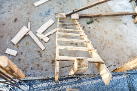 Wood ladder on construction site, tools and concrete renovationの写真素材