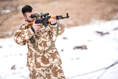 Military army trooper, ranger firing and shooting with gun