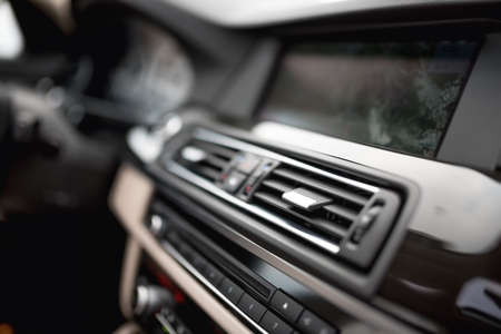 modern car interior with close-up of ventilation system holes and air conditioning. Concept wallpaper for auto air conditioning and dashboardの写真素材