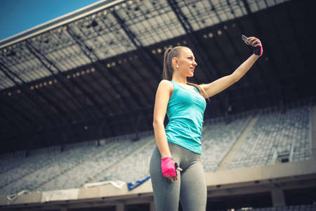 Young woman taking selfie with phone camera. Modern social media conceptの写真素材