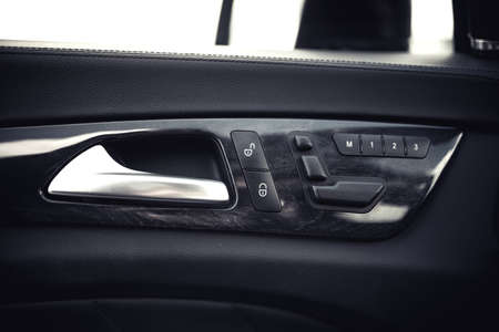 Modern car interior details. Door handle and electronic memory for the chairs.の写真素材