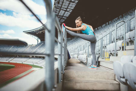 Athletic woman going for a jog or run at running track. Healthy fitness conceptの写真素材