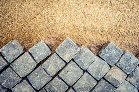 Construction of pavement details, cobblestone pavement, stone blocks on road construction siteの写真素材