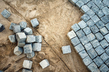 Pavement rocks, stones and cobblestone blocks, construction of path, road or sidewalkの写真素材