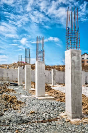 Reinforced steel bars on construction pillars, concrete details and beams at buildng site.