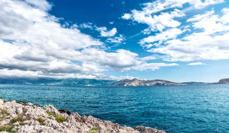Panoramic view of island coastline landscape, calm water, clear sky on a sunny vacation day. Seaside resort as exotic destinationの写真素材