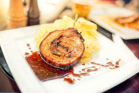 delicious dinner at restaurant, grilled pork chop with chips potatoes as main dishの写真素材