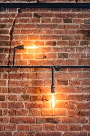 home decoration walls with lamps, pipes and bricks. Old and vintage looking wall, interior designの写真素材