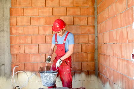 industrial construction worker, builder, working on construction site.の写真素材