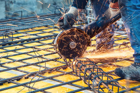 construction engineer using a circular saw cutting reinforced steel and barsの写真素材