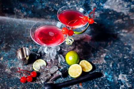 cosmopolitan alcoholic cocktail drink at casino and bar served with lime, ice and cherries
