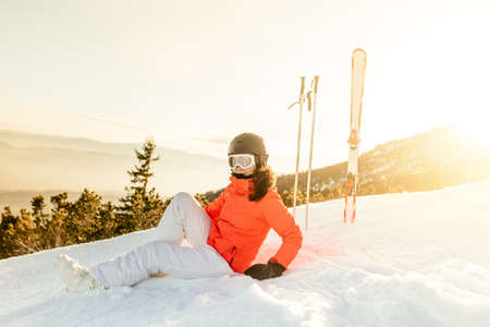 young woman enjoying the view from mountain slopes, relaxing