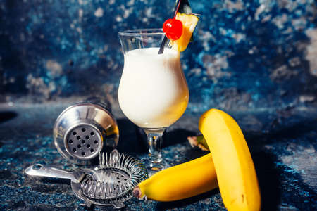 pina colada alcoholic fresh cocktail served cold with coconut and banana at barの写真素材