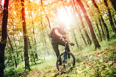 downhill mountain trail competition, cyclist performing on mountain bikeの写真素材