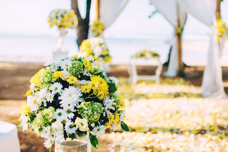 Flower decoration, details of beach wedding set up. Romantic and private ceremony of bride and groom の写真素材