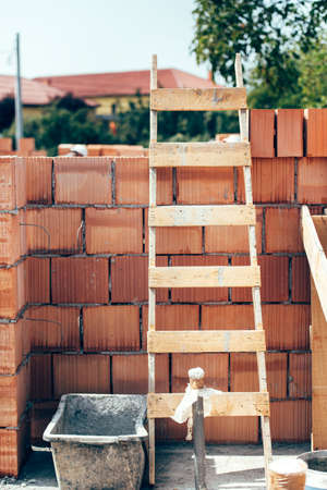 Wooden ladder on building construction site. Details of masonry and wooden toolsの写真素材
