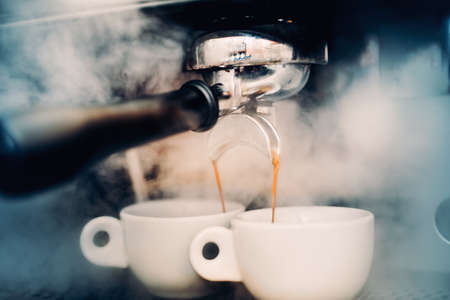 Espresso details. two perfect cups of coffee. Coffee Preparation concept at bar, pub or restaurant.の写真素材
