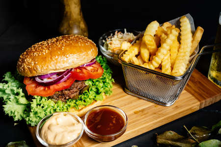 Tasty, delicious, beef burger with fresh vegetables, fries and coleslawの写真素材