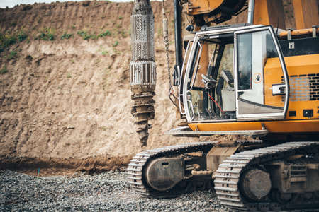 Construction site, highway building with industrial rotary drilling machinery close upの写真素材