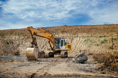 Highway construction site details - engineer working with excavator and loading gravel, soil and earthの写真素材