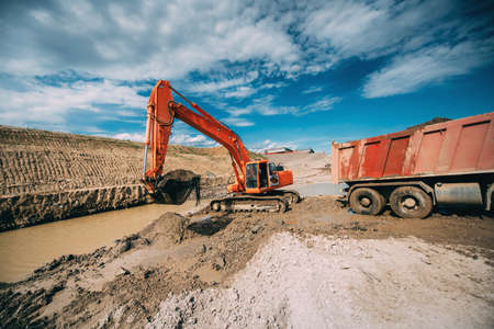 construction industry - excavator working on highway construction site. Details of digging in water...