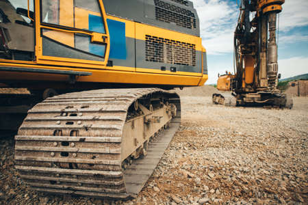 close up details of excavator tracks on construction site
