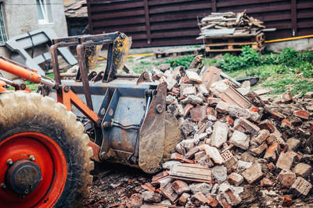 Hydraulic crusher excavator backoe machinery working on site demolition during renovation worksの写真素材